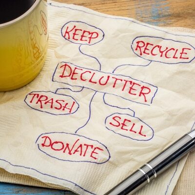 declutter concept on napkin declutter concept (keep, recycle, trash, sell, donate - handwriting on napkin with a cup of coffee